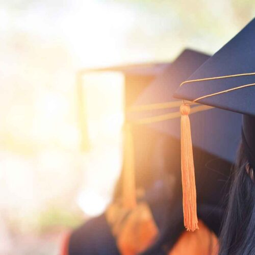 Graphic displaying students with tasseled graduation hats.